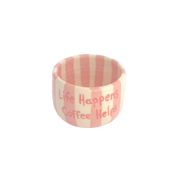 taza espresso con rayas rosas pastel y frase life happens coffee heps