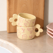 tazas de cerámica con asa de flor en color amarillo mantequilla y flores pintadas en rosa pastel